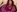 Photo of a sitting on the floor wearing a purple kurta